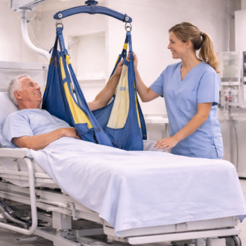 Caregiver using ceiling-mounted patient lift to safely transfer patient in bed.