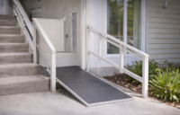 Residential platform lift installed at home entrance for wheelchair accessibility.