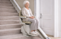 Stair lift installed in home to help elderly woman safely navigate stairs.